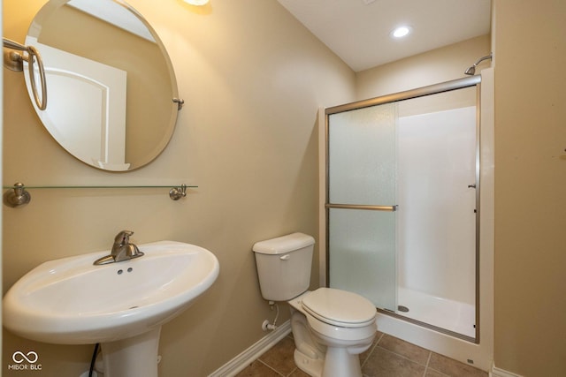 3792 Waterfront Way, Plainfield, IN 46168 - bathroom with tile patterned flooring, baseboards, toilet, a stall shower, and a sink