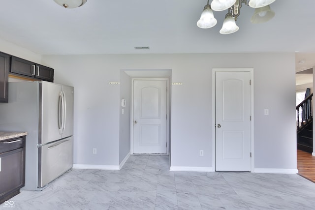 5944 Edelle Dr, Indianapolis, IN 46237 - kitchen featuring visible vents, marble finish floor, freestanding refrigerator, light countertops, and baseboards
