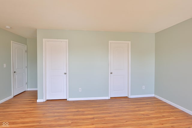 5944 Edelle Dr, Indianapolis, IN 46237 - unfurnished bedroom with baseboards and light wood finished floors