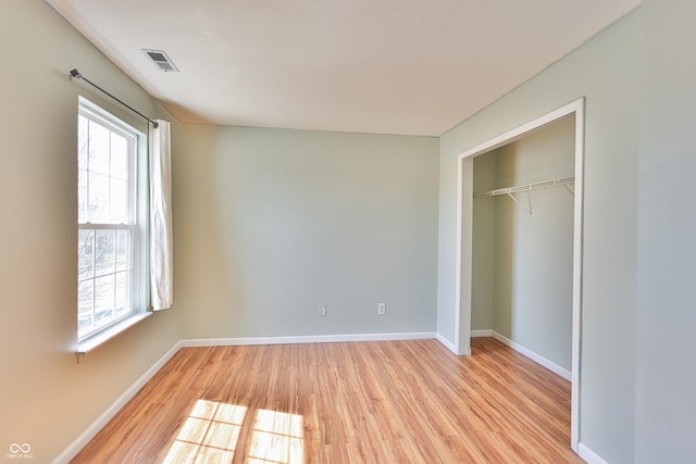5944 Edelle Dr, Indianapolis, IN 46237 - unfurnished bedroom with a closet, visible vents, light wood-type flooring, and baseboards
