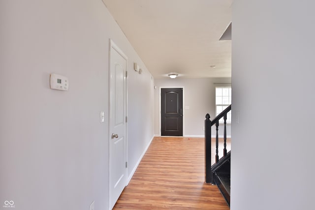 5944 Edelle Dr, Indianapolis, IN 46237 - hallway featuring baseboards, an upstairs landing, and light wood finished floors