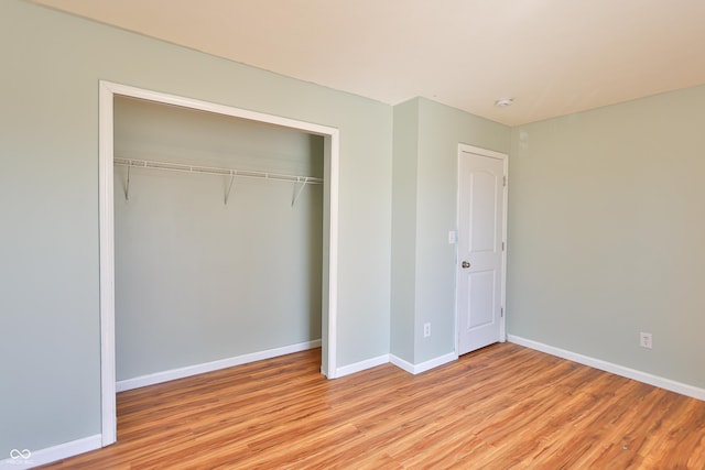 5944 Edelle Dr, Indianapolis, IN 46237 - unfurnished bedroom with a closet, baseboards, and light wood finished floors