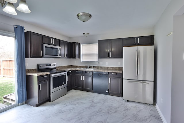 5944 Edelle Dr, Indianapolis, IN 46237 - kitchen with dark countertops, baseboards, appliances with stainless steel finishes, marble finish floor, and a sink