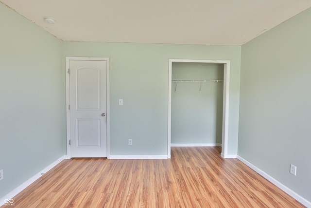 5944 Edelle Dr, Indianapolis, IN 46237 - unfurnished bedroom featuring a closet, baseboards, and light wood-style floors