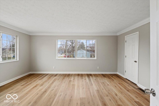 unfurnished bedroom with light wood-style flooring, a textured ceiling, baseboards, and ornamental molding