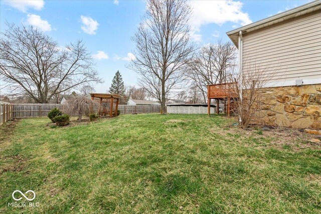view of yard featuring a deck and a fenced backyard