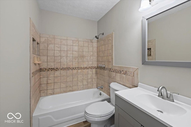 full bathroom with shower / bathing tub combination, toilet, vanity, and a textured ceiling