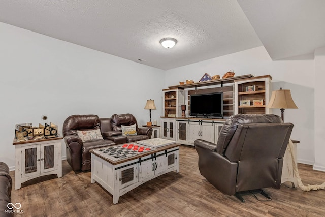 1521 Avondale Dr, Westfield, IN 46074 - living area with wood finished floors, a textured ceiling, and baseboards