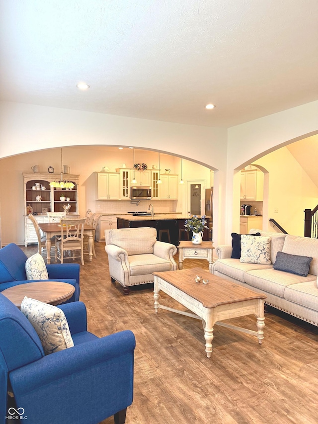 1521 Avondale Dr, Westfield, IN 46074 - living area with arched walkways, wood finished floors, and recessed lighting