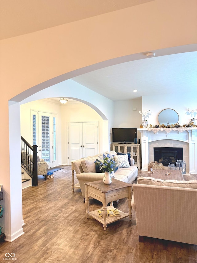 1521 Avondale Dr, Westfield, IN 46074 - living area featuring wood finished floors, a fireplace, arched walkways, baseboards, and stairway