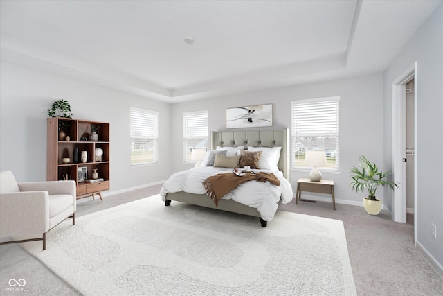 bedroom featuring baseboards, light colored carpet, and a raised ceiling