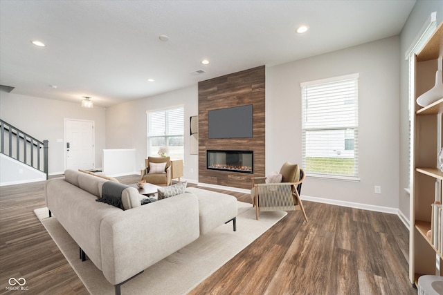 living area with baseboards, stairs, a fireplace, recessed lighting, and dark wood finished floors