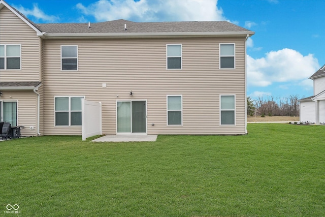 back of property with a lawn and a patio