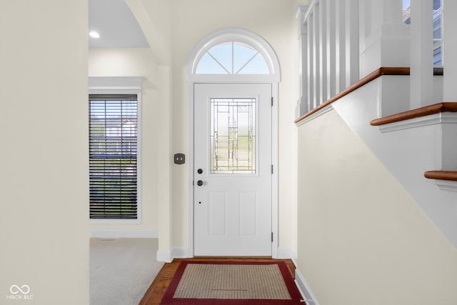 doorway with baseboards and plenty of natural light