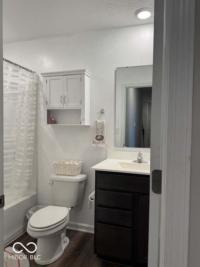 full bath featuring toilet, shower / tub combo with curtain, vanity, wood finished floors, and baseboards