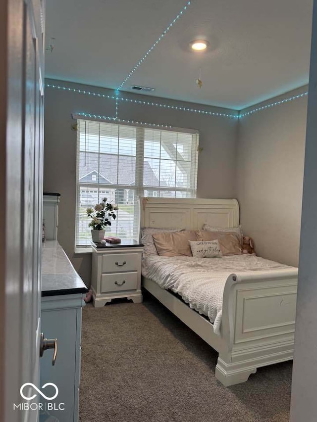 bedroom with dark colored carpet