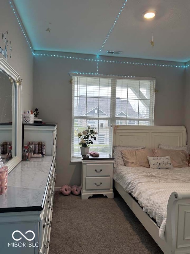 bedroom with visible vents and carpet