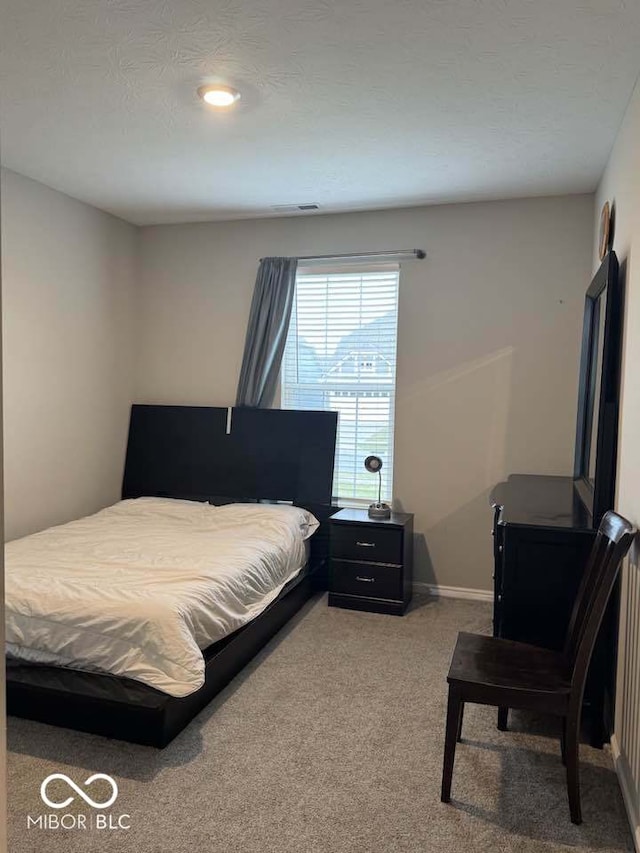carpeted bedroom with baseboards and visible vents