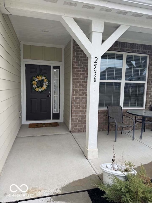 property entrance with brick siding