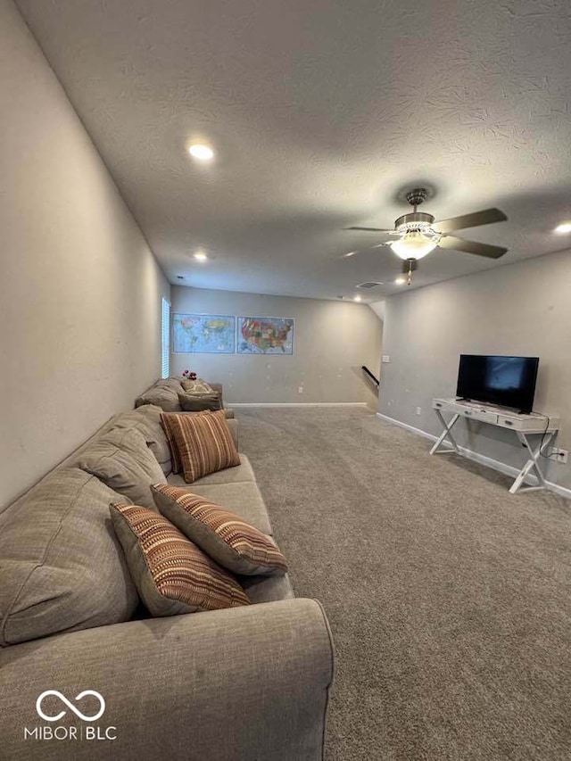 carpeted living room featuring baseboards, a textured ceiling, and ceiling fan