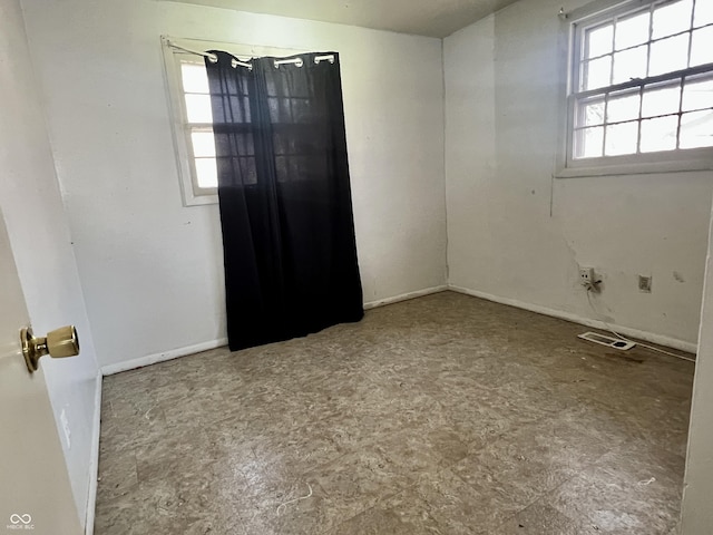 empty room featuring visible vents and baseboards