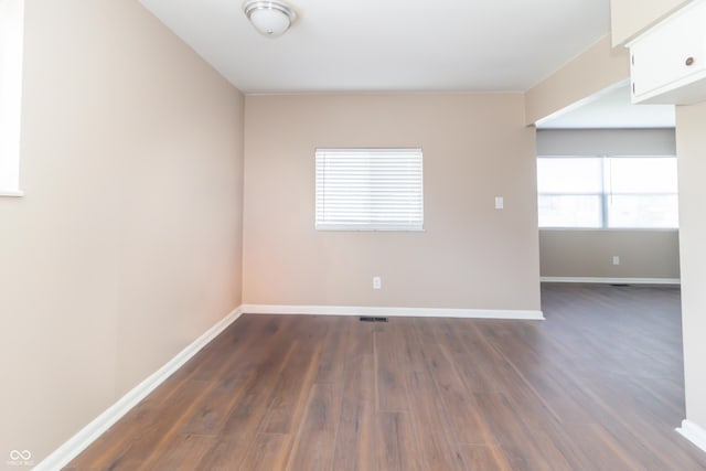 1701 Nelson Ave, Indianapolis, IN 46203 - unfurnished room featuring baseboards and dark wood-style flooring