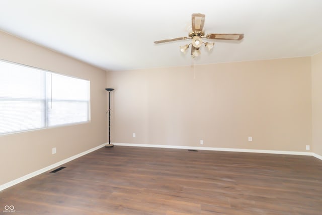 1701 Nelson Ave, Indianapolis, IN 46203 - unfurnished room featuring dark wood-type flooring, baseboards, visible vents, and ceiling fan
