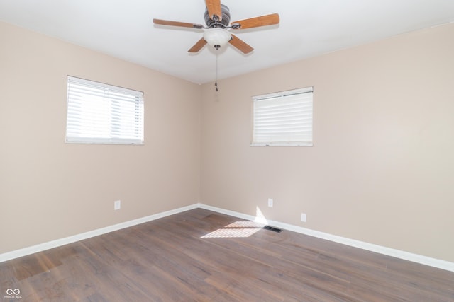 1701 Nelson Ave, Indianapolis, IN 46203 - empty room with baseboards, dark wood-type flooring, and a ceiling fan
