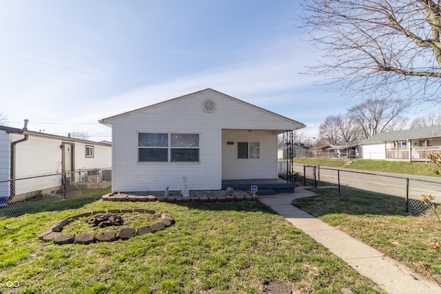 1701 Nelson Ave, Indianapolis, IN 46203 - view of front facade featuring an outdoor fire pit, a front lawn, and fence