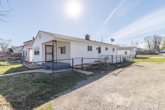 1701 Nelson Ave, Indianapolis, IN 46203 - view of front of home featuring a chimney, a front lawn, and fence