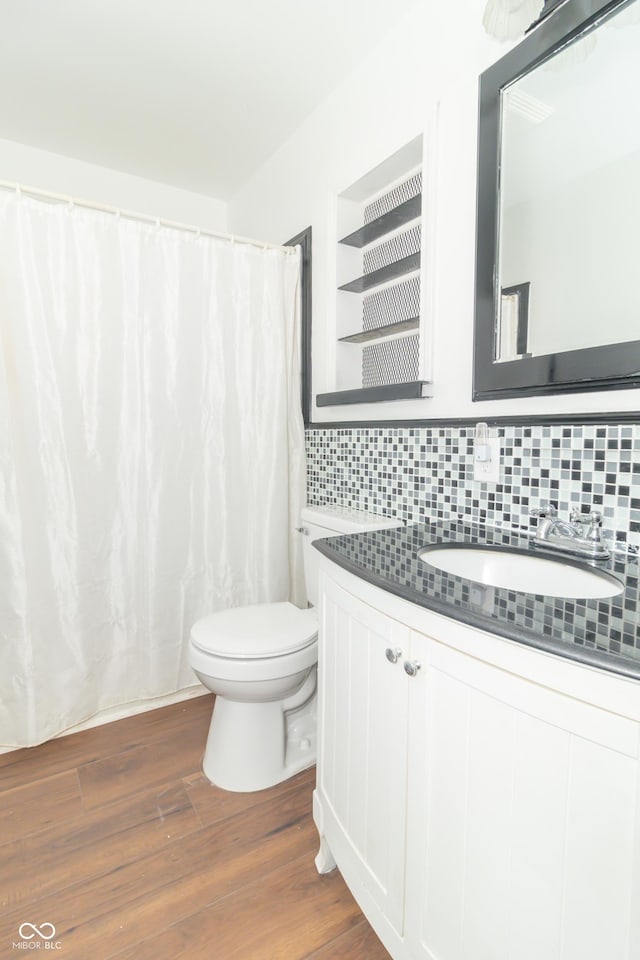 1701 Nelson Ave, Indianapolis, IN 46203 - bathroom with vanity, wood finished floors, curtained shower, toilet, and backsplash