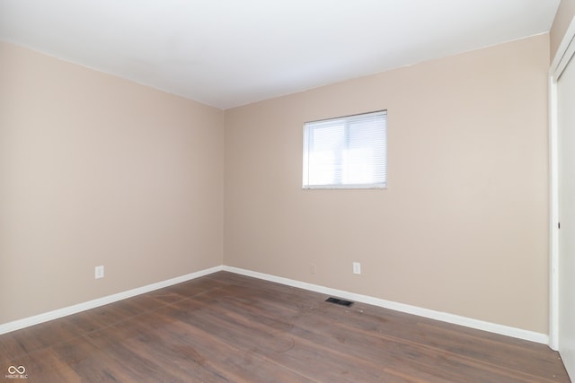 1701 Nelson Ave, Indianapolis, IN 46203 - empty room with visible vents, baseboards, and dark wood-style flooring