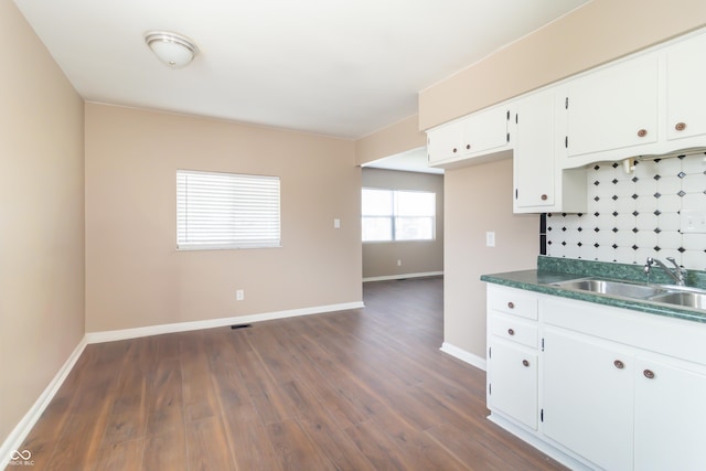 1701 Nelson Ave, Indianapolis, IN 46203 - kitchen featuring decorative backsplash, dark wood-type flooring, baseboards, and a sink