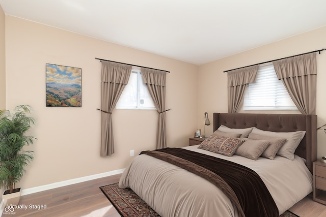 1701 Nelson Ave, Indianapolis, IN 46203 - bedroom featuring multiple windows, baseboards, and wood finished floors