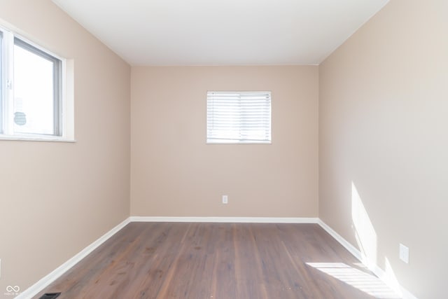 1701 Nelson Ave, Indianapolis, IN 46203 - spare room with visible vents, baseboards, and wood finished floors