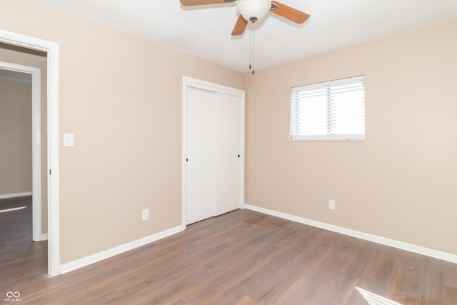 1701 Nelson Ave, Indianapolis, IN 46203 - unfurnished bedroom with a closet, ceiling fan, baseboards, and wood finished floors