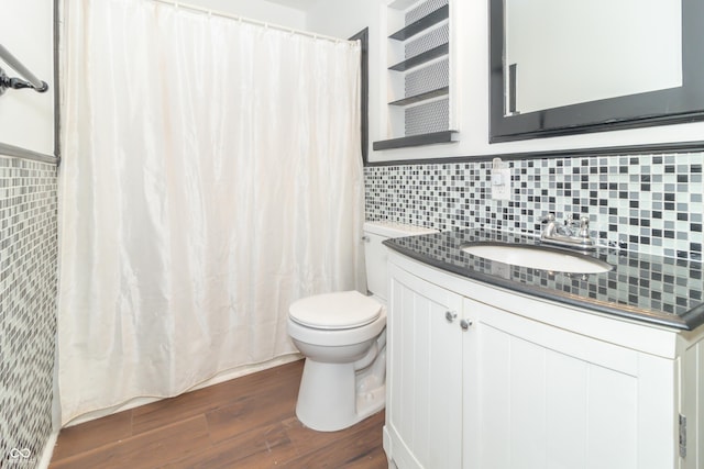 1701 Nelson Ave, Indianapolis, IN 46203 - bathroom featuring a shower with curtain, toilet, tasteful backsplash, wood finished floors, and vanity
