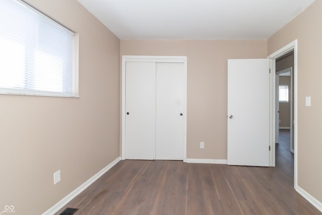1701 Nelson Ave, Indianapolis, IN 46203 - unfurnished bedroom featuring a closet, baseboards, visible vents, and wood finished floors