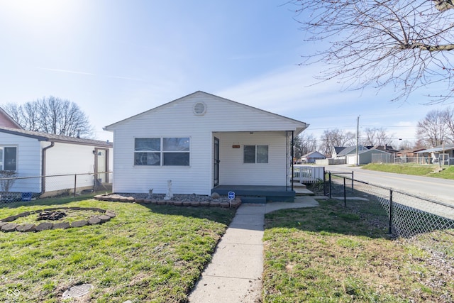 1701 Nelson Ave, Indianapolis, IN 46203 - bungalow-style house featuring a front yard, fence, and a fire pit