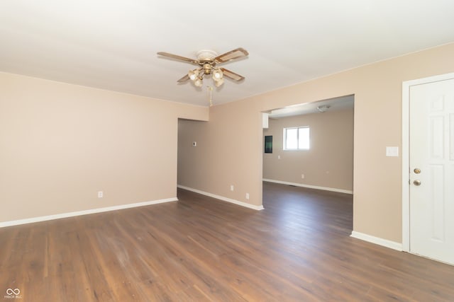 1701 Nelson Ave, Indianapolis, IN 46203 - empty room with dark wood-style floors, baseboards, and ceiling fan