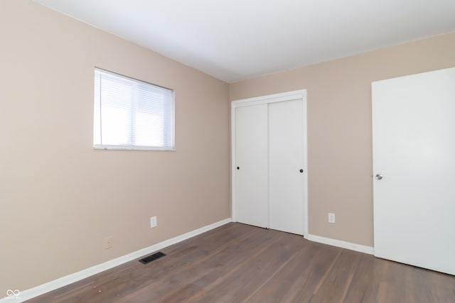 1701 Nelson Ave, Indianapolis, IN 46203 - unfurnished bedroom featuring visible vents, baseboards, a closet, and wood finished floors
