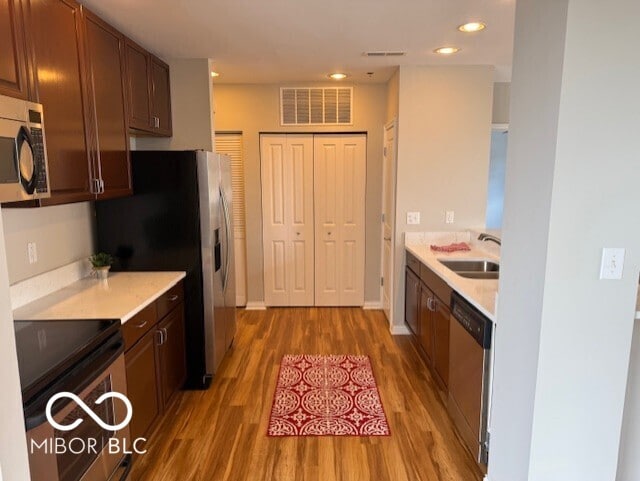110 E Washington St Unit 802, Indianapolis, IN 46204 - kitchen featuring appliances with stainless steel finishes, light wood-style flooring, light countertops, and recessed lighting