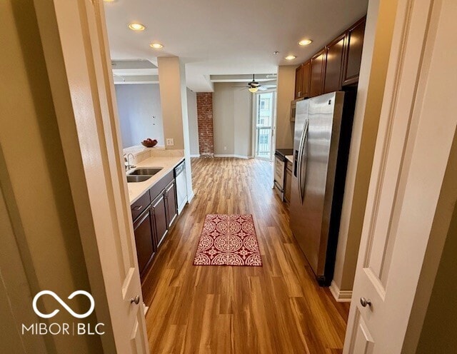 110 E Washington St Unit 802, Indianapolis, IN 46204 - kitchen featuring appliances with stainless steel finishes, wood finished floors, light countertops, dark brown cabinetry, and recessed lighting
