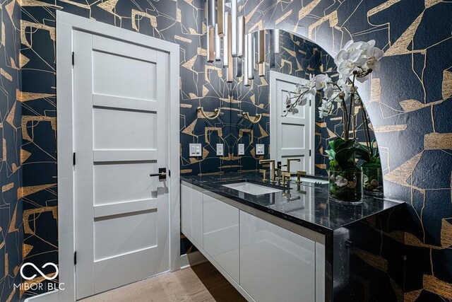 395 Breakwater Dr, Fishers, IN 46037 - bar featuring a sink, wood finished floors, and wallpapered walls