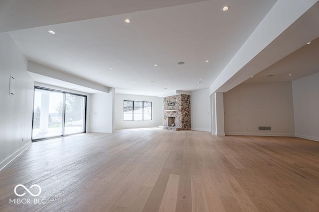 395 Breakwater Dr, Fishers, IN 46037 - unfurnished living room featuring light wood-style flooring, recessed lighting, baseboards, and visible vents