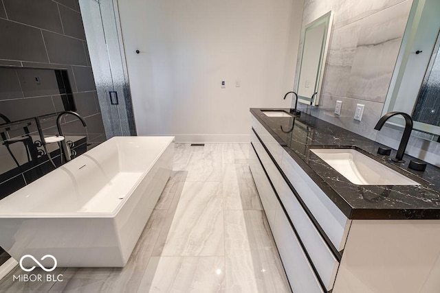 395 Breakwater Dr, Fishers, IN 46037 - bathroom featuring marble finish floor, a sink, a freestanding tub, and double vanity
