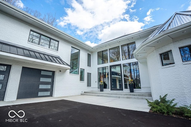 395 Breakwater Dr, Fishers, IN 46037 - view of exterior entry featuring stucco siding and a garage