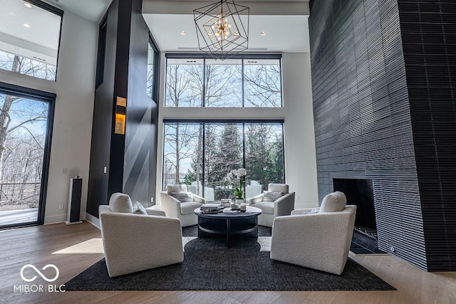 395 Breakwater Dr, Fishers, IN 46037 - living area with a towering ceiling, a chandelier, and wood finished floors
