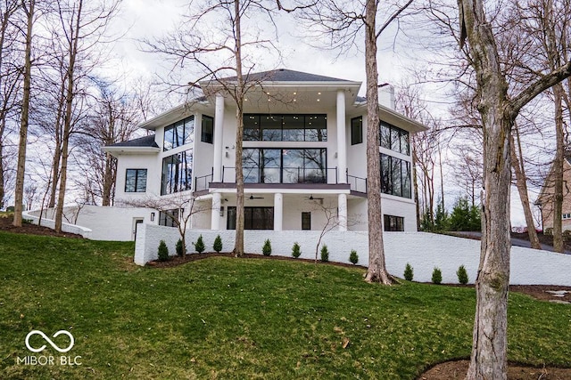 395 Breakwater Dr, Fishers, IN 46037 - rear view of property with stucco siding, a ceiling fan, a yard, and a balcony