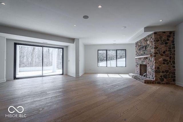 395 Breakwater Dr, Fishers, IN 46037 - unfurnished living room with baseboards, a fireplace, recessed lighting, and hardwood / wood-style flooring
